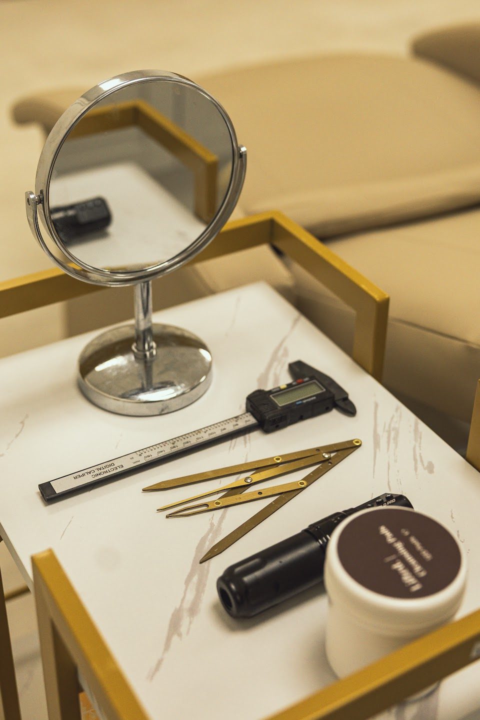 Brow and lash tools on a marble tray