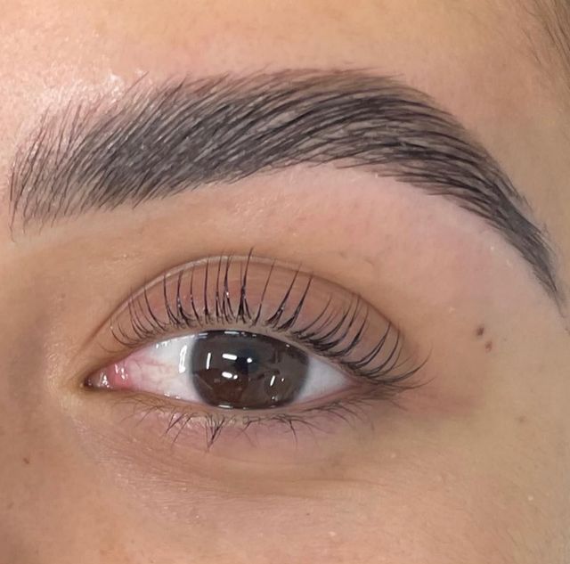 Close-up of lifted lashes with a brushed up natural brow