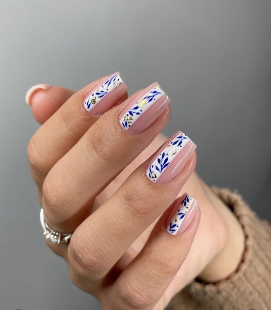 Hand painted blue botanical nail art on gel nails