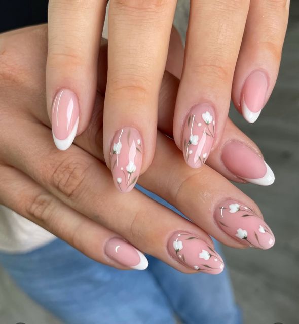 Classic French manicure with delicate floral accent nails