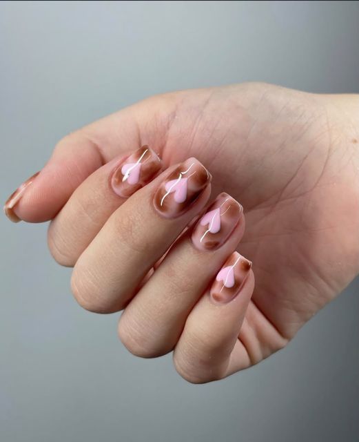 Soft pink and chocolate gel nails with subtle nail art