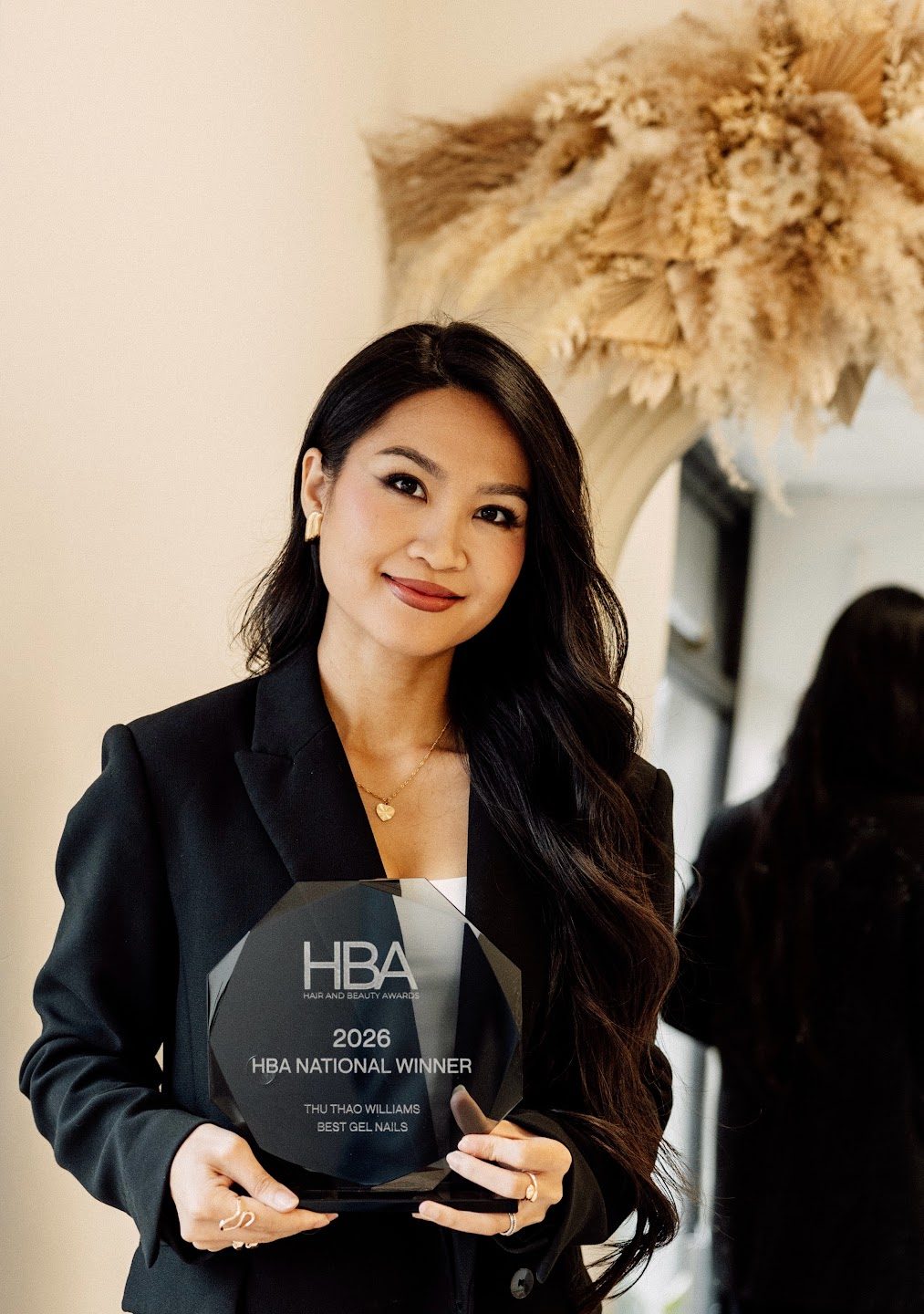 Sunny Williams, founder of Suukkosan, holding her HBA National Winner award